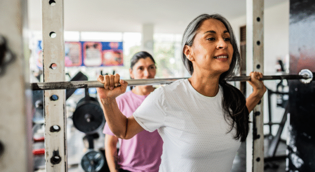 Mature woman doing exercises at gym